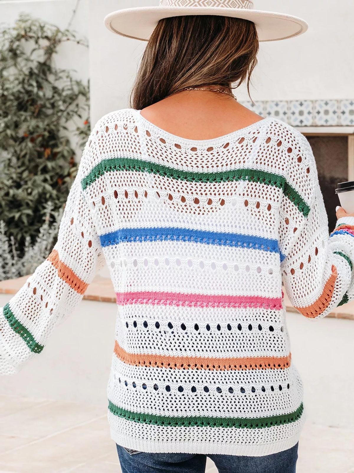 Trendsi color block striped pointelle knit sweater showing a cozy, multicolored pattern with ribbed cuffs and a round neckline.