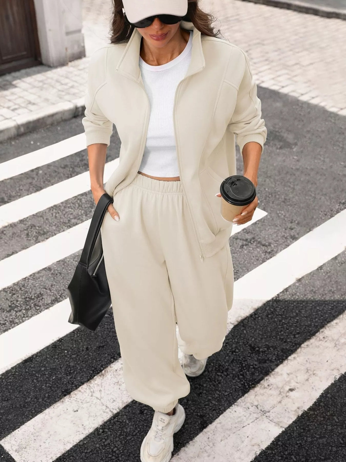 Women's zip-up long sleeve top and pants set by Trendsi, featuring a coordinated, comfortable loungewear outfit in soft fabric.