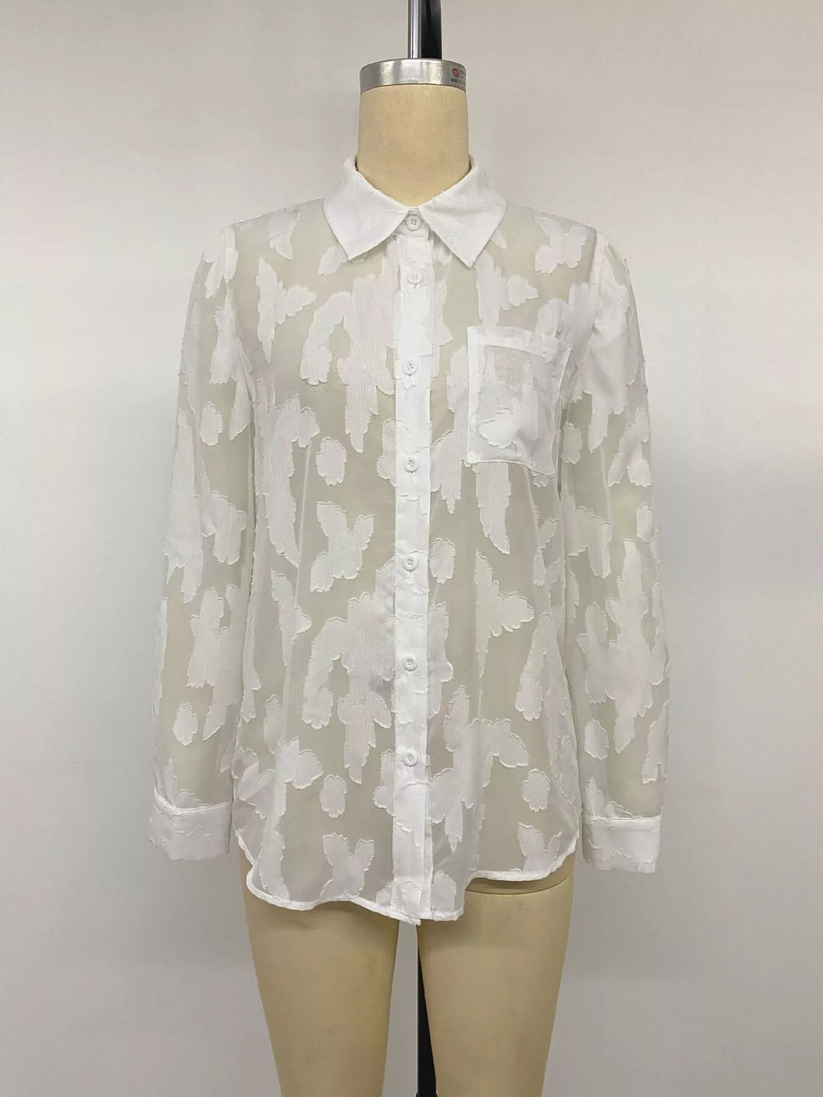 Sheer button-down shirt from Trendsi, lightweight and transparent, shown on a hanger with a collar and long sleeves.