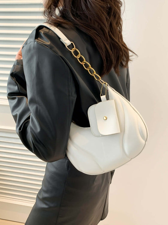 PU Leather Shoulder Bag with EarPods Bag in white, worn by a person in a black outfit.