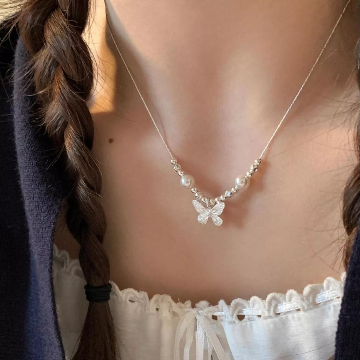 Elegant butterfly pearl pendant necklace from Plush Fashion Hub featuring a delicate pearl and butterfly design.