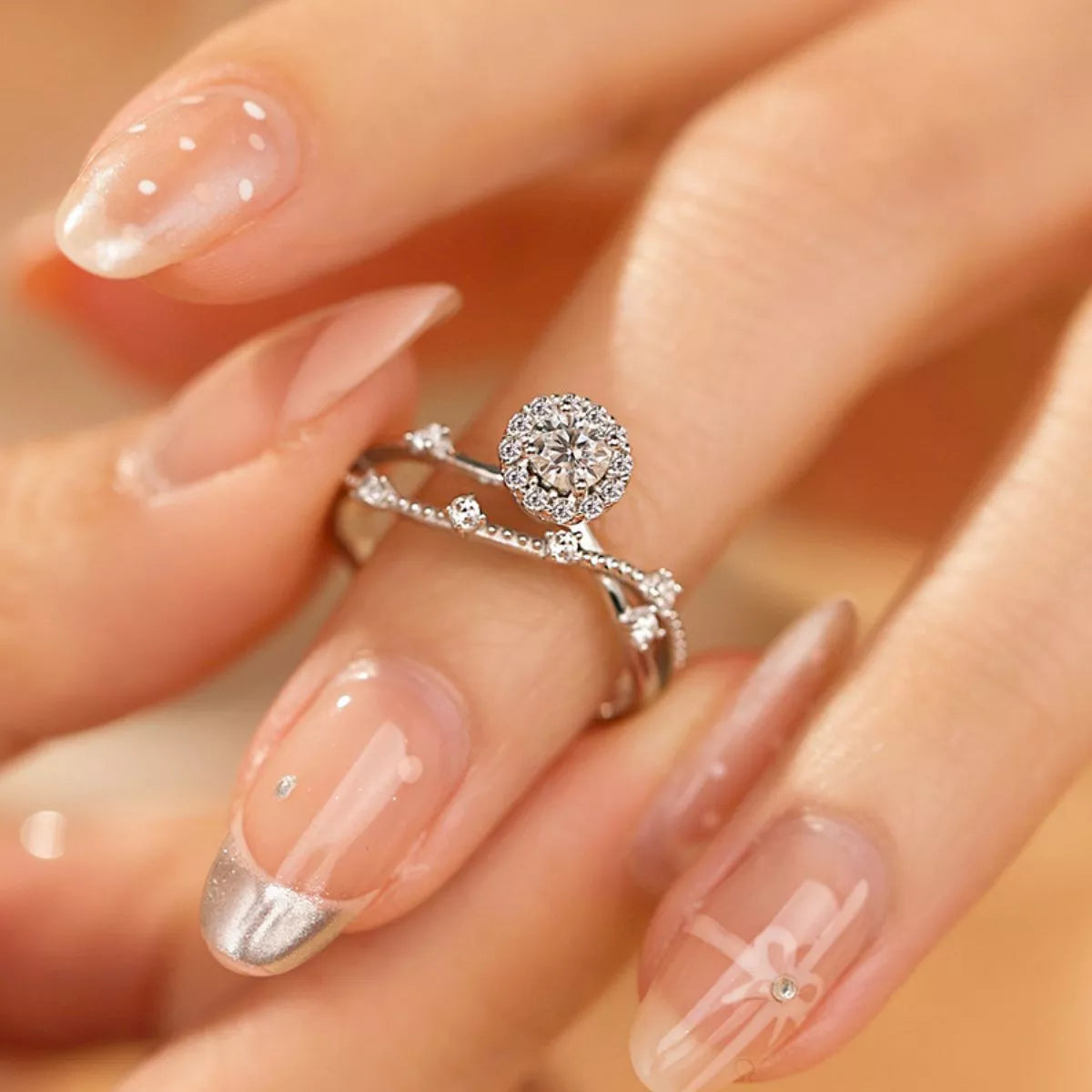 Sterling silver layered ring with 1 carat moissanite gemstone, featuring a stylish design and polished finish.