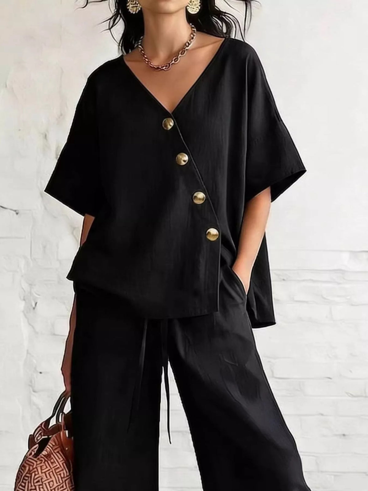 Plus size full surplice half sleeve top and wide-leg pants set by Trendsi, featuring a stylish matching outfit with relaxed fit.