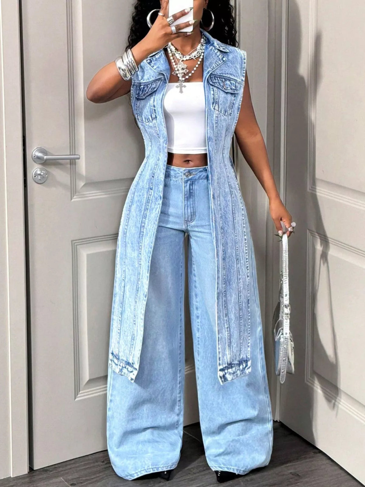 Open front denim vest with high-low hem from Trendsi, stylish casual top featuring distressed details and a trendy fit.