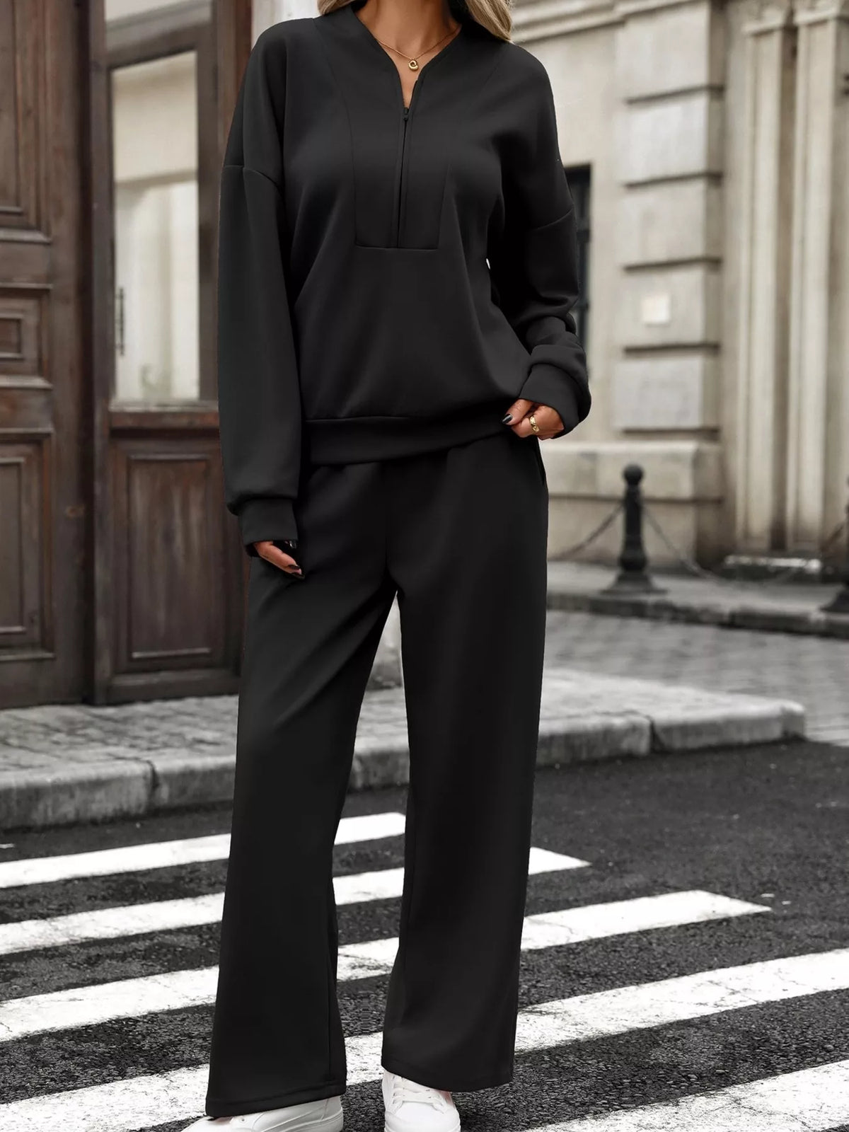 Women’s half zip sweatshirt and wide-leg pants set by Trendsi, featuring a cozy sweatshirt and relaxed-fit pants in a coordinated look.