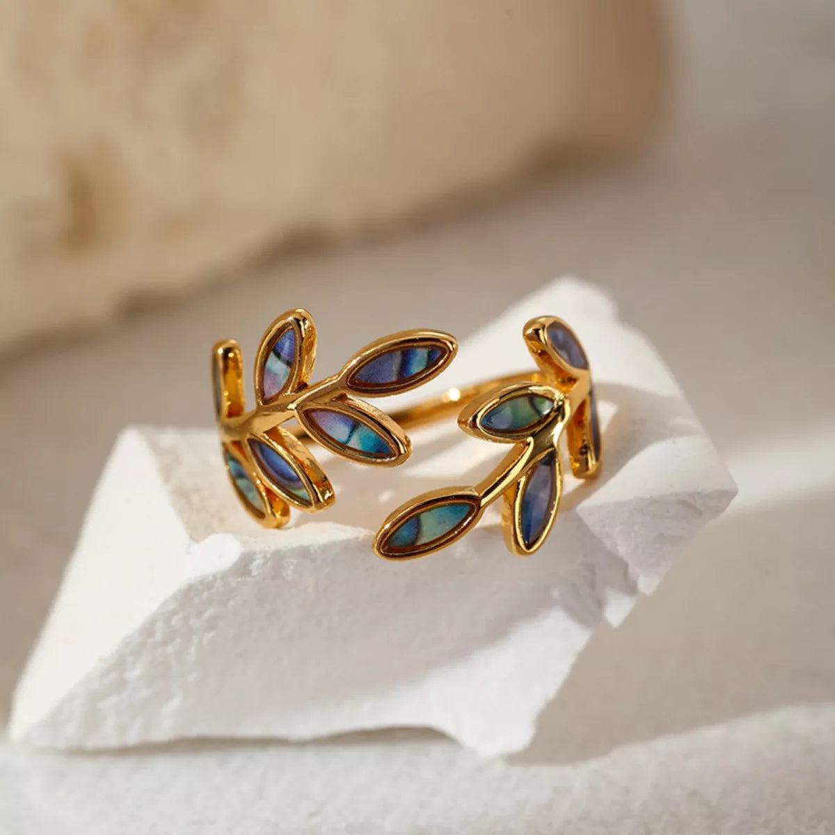 18K gold-plated resin leaf bypass ring with smooth band and detailed leaf design, showcasing elegant jewelry craftsmanship.