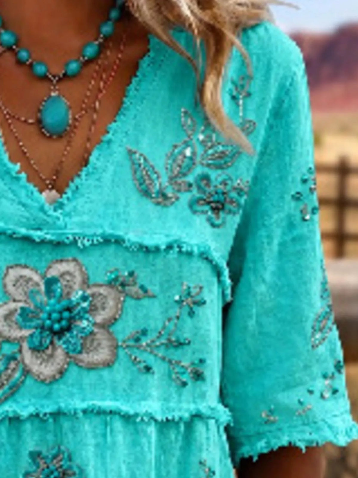 Plus size floral raw hem V-neck blouse by Trendsi, featuring a full-size shirt with a feminine floral pattern and casual raw hem detail.