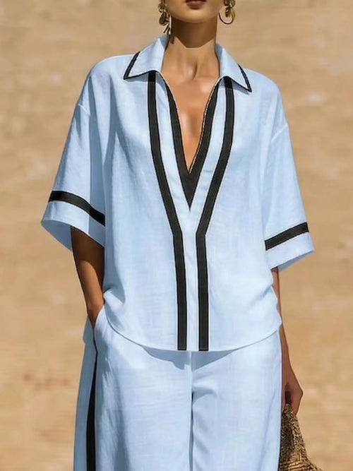 Plus size contrast trim top and pants set from Trendsi, featuring a stylish coordinated outfit with contrasting details.