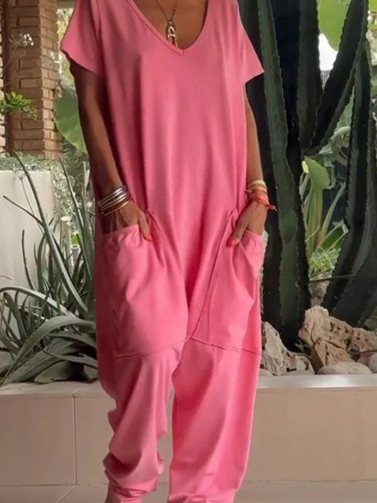 Plus size loose fit V-neck short sleeve jumpsuit with wide legs, stylish and comfortable from Trendsi.