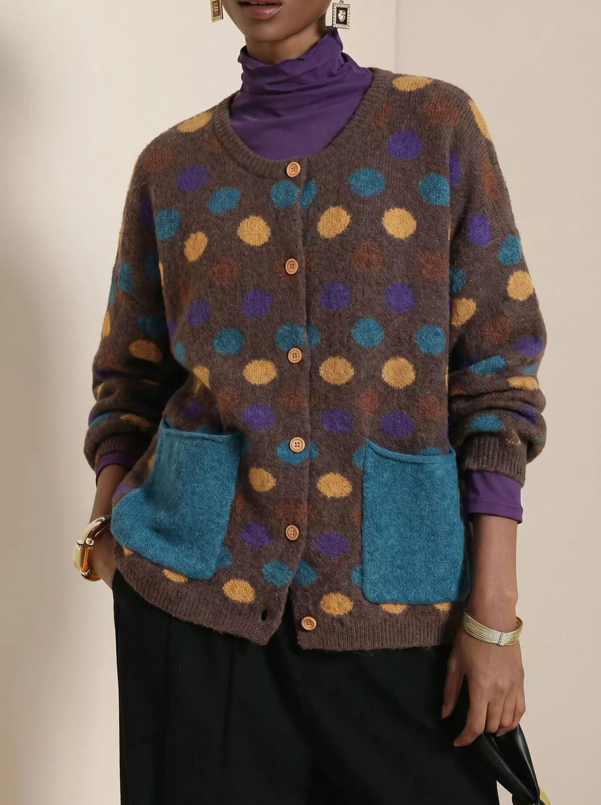Plus size polka dot button-down cardigan by Trendsi, featuring a full-size design and long sleeves, styled for casual wear.