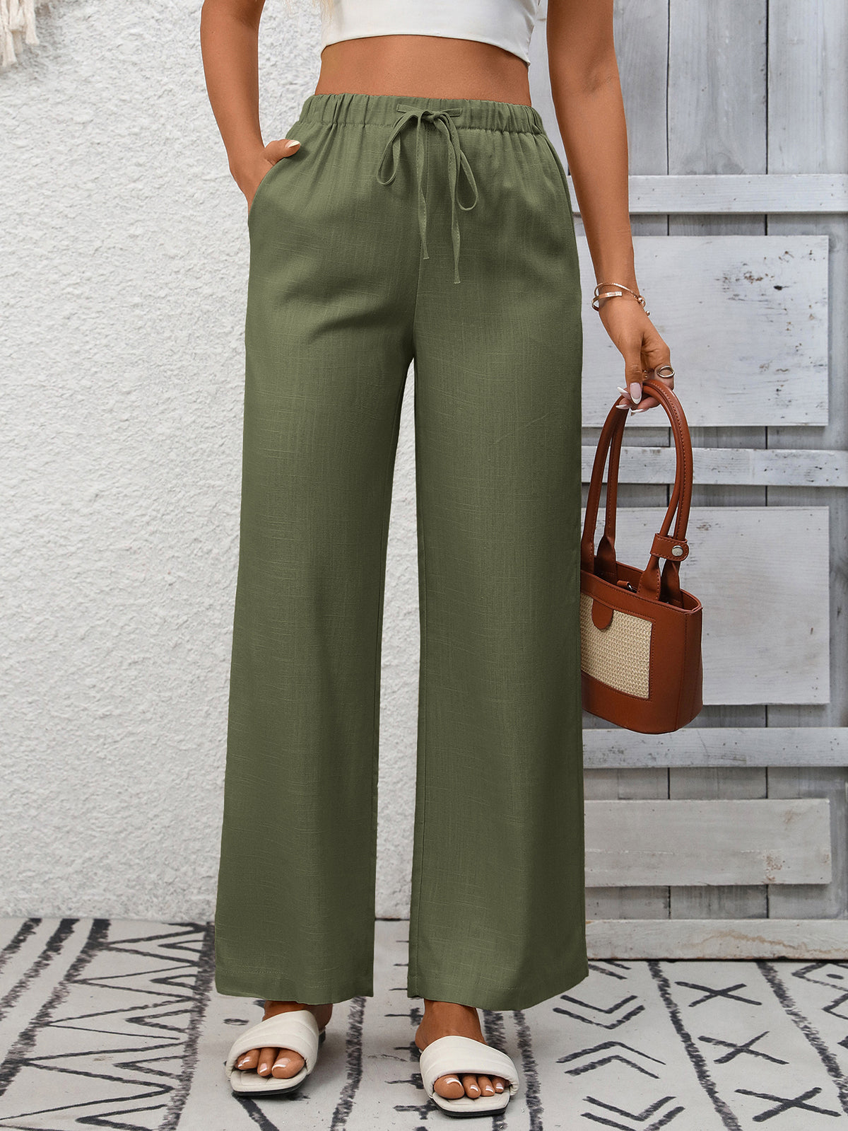 Women's high-waisted wide-leg drawstring pants in soft breathable viscose, featuring relaxed fit and comfortable design.