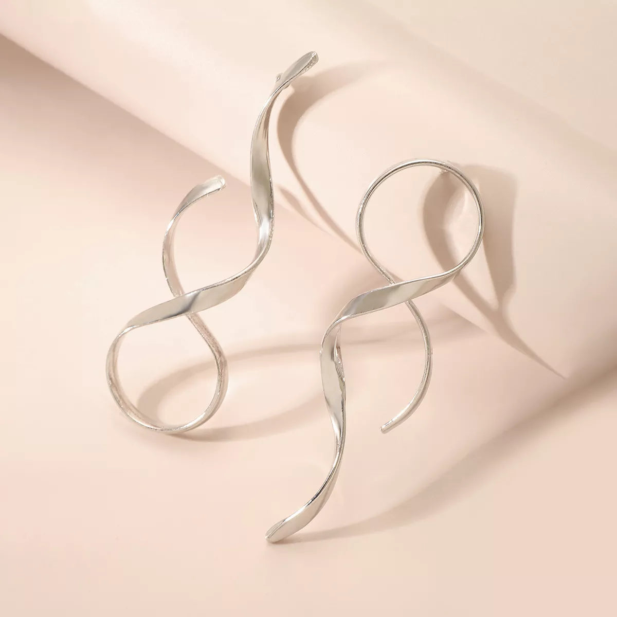 Plush Fashion Hub alloy spiral drop earrings with a sleek, modern design and shiny metallic finish.