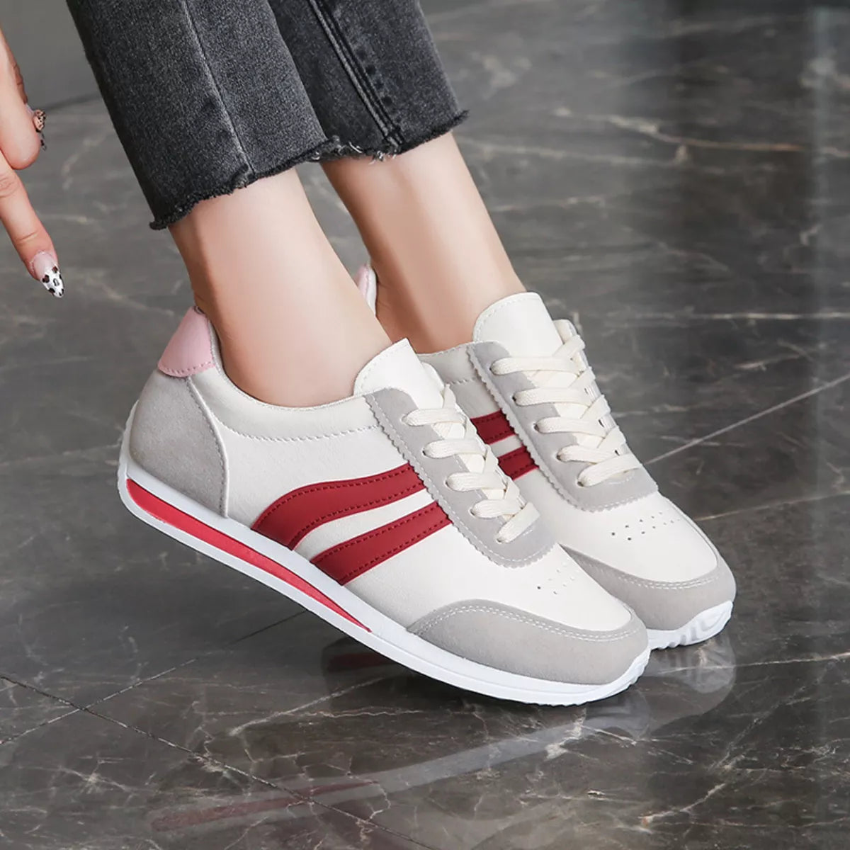 Women’s round toe lace-up sneakers by Trendsi, featuring a stylish design and white laces on a casual sneaker style.
