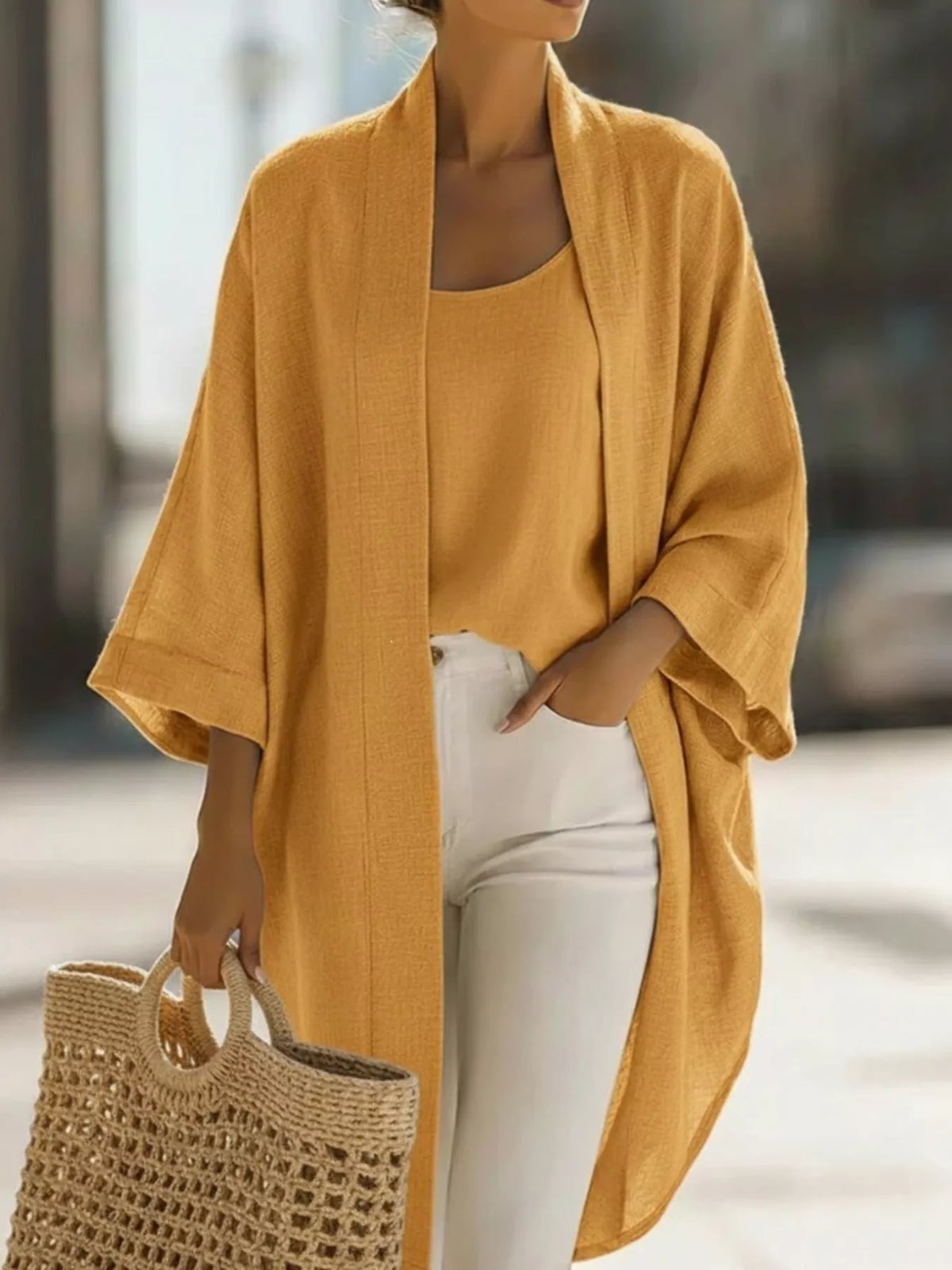 Plus size open-front cardigan and matching tank top set by Trendsi, featuring soft knit fabric and relaxed fit for casual wear.
