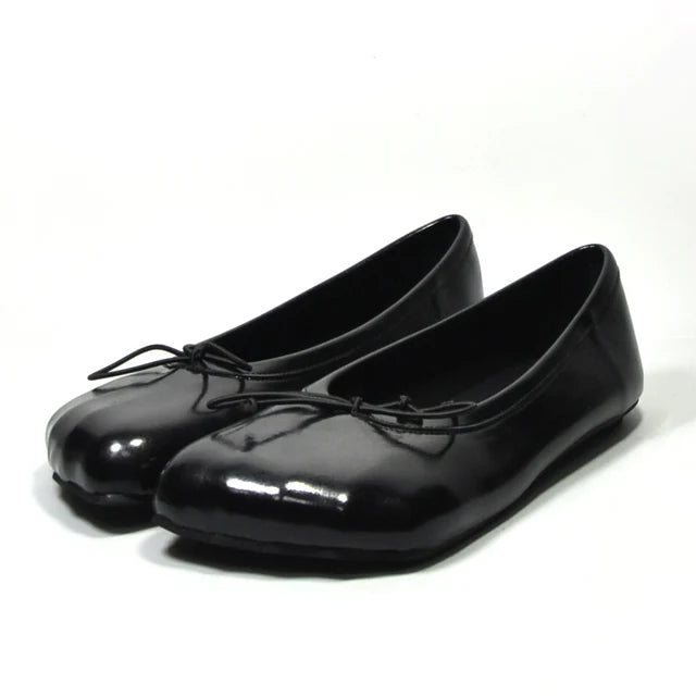 Glossy black ballet flat loafers with a rounded toe, slip-on style, and a delicate tie detail at the top.