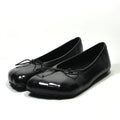 Glossy black ballet flat loafers with a rounded toe, slip-on style, and a delicate tie detail at the top.
