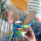 Liyke pointed-toe stilettos in a blue, green, and white geometric satin print with dual front straps and high heels.