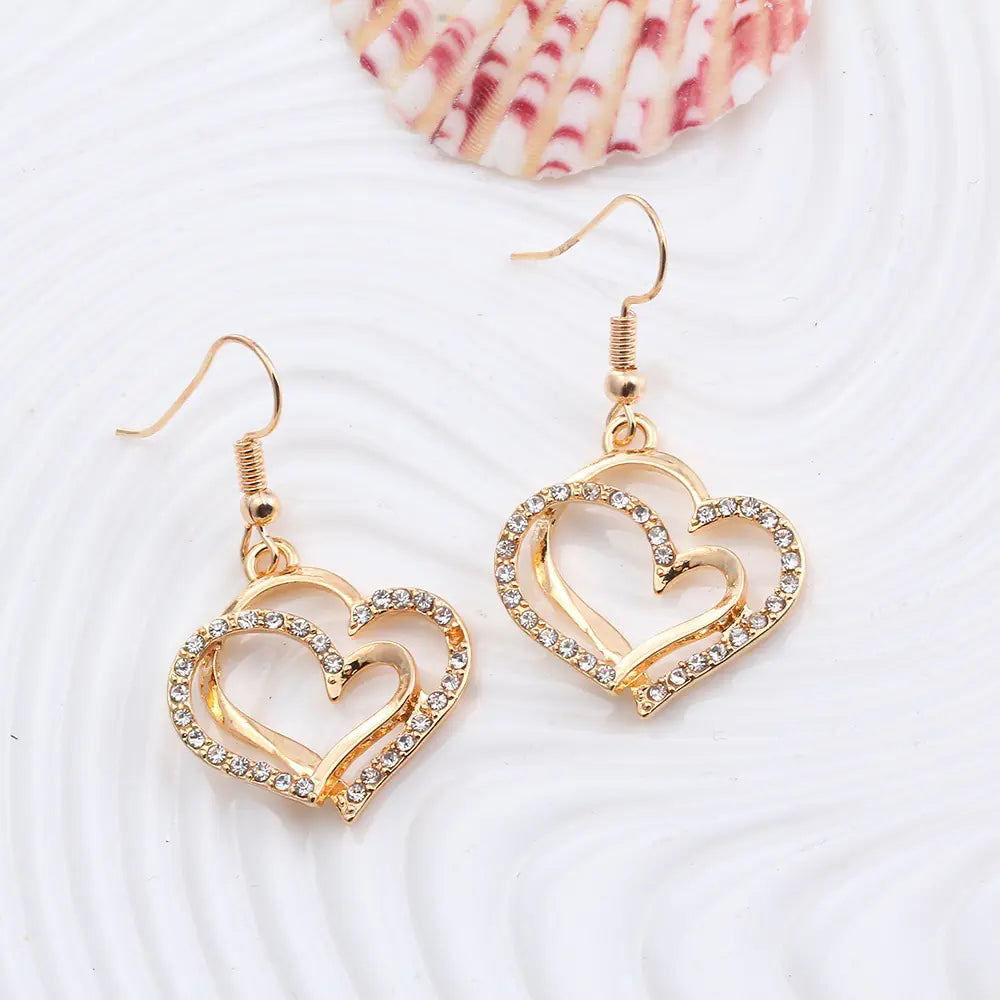 Double heart wedding jewelry set by Plush Fashion Hub featuring a matching necklace and earrings with elegant heart designs.