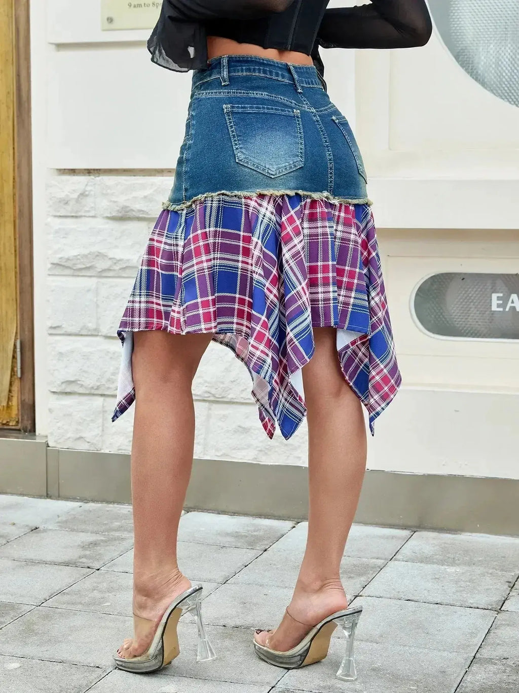 Asymmetric plaid hem denim skirt with functional pockets, trendy and stylish by Trendsi, shown in a casual fashion setting.