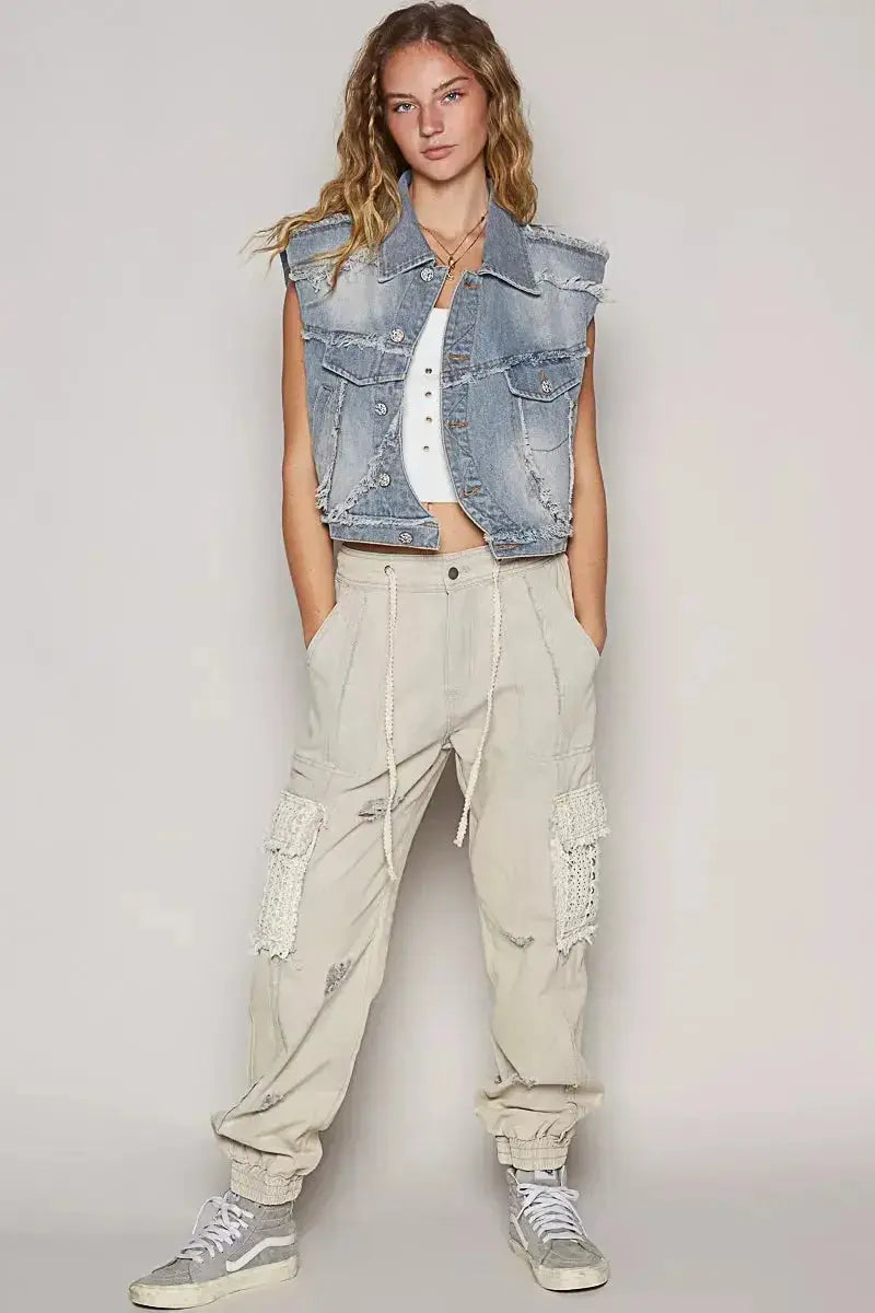 Asymmetrical distressed denim vest with raw hem and sleeveless design from Plush Fashion Hub, showcasing trendy raw-edge jean jacket style.