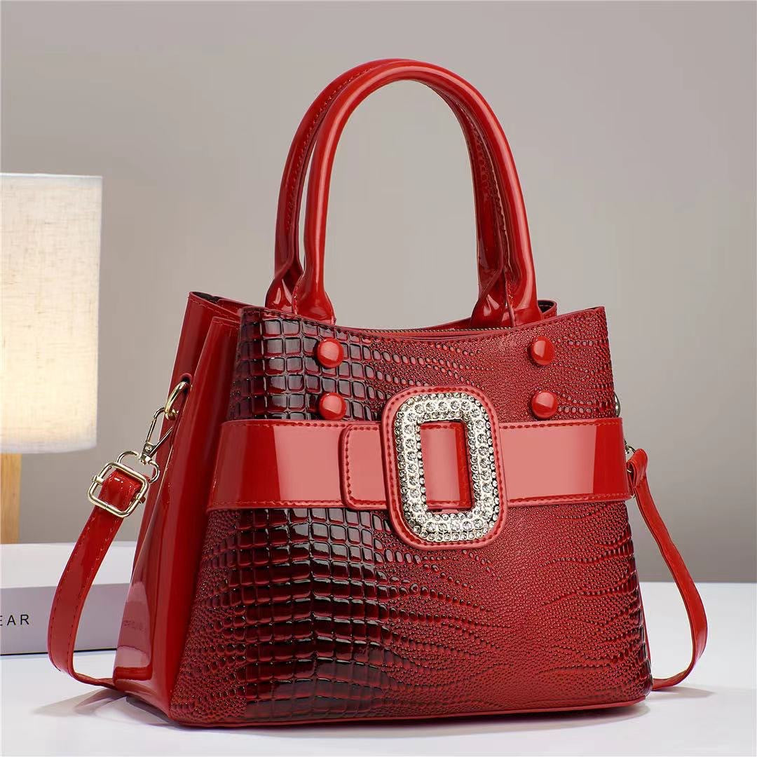 Lizard patterned mini bucket crossbody bag with zipper from Plush Fashion Hub, featuring a stylish and compact design.