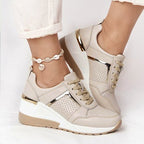 Beige mesh platform sneakers with gold metallic accents, white soles, and matching beige laces.