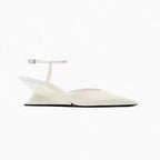 Elegant white pointed-toe wedge sandals with a thin buckled ankle strap and a translucent sculptural wedge heel.