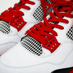 Red elastic shoelace by Bread, showing its flexible, stretchy material and vibrant color ideal for casual footwear.