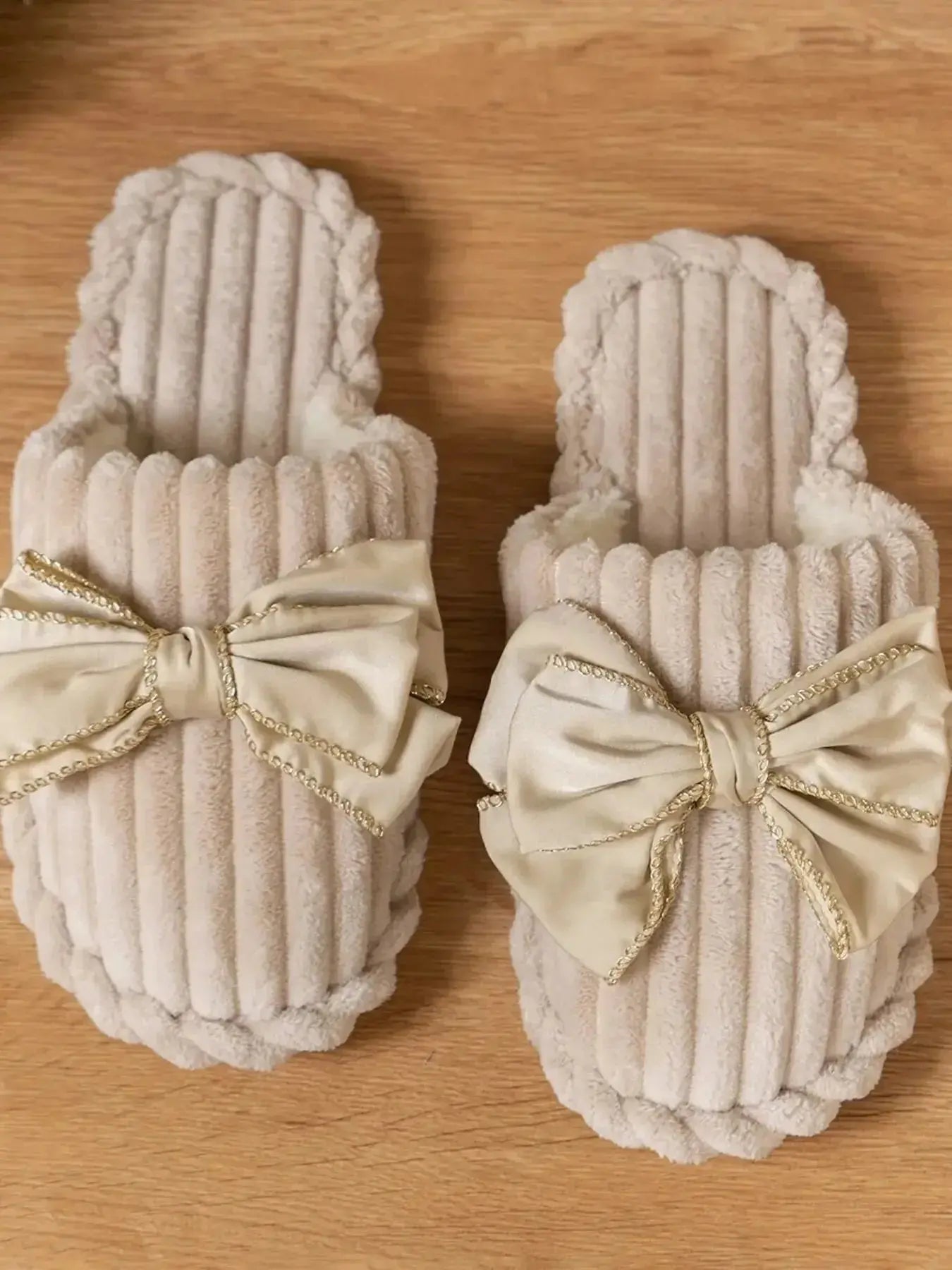 Women's bow-embellished cozy indoor slippers with cushioned EVA sole from Plush Fashion Hub, featuring soft plush material and stylish design.