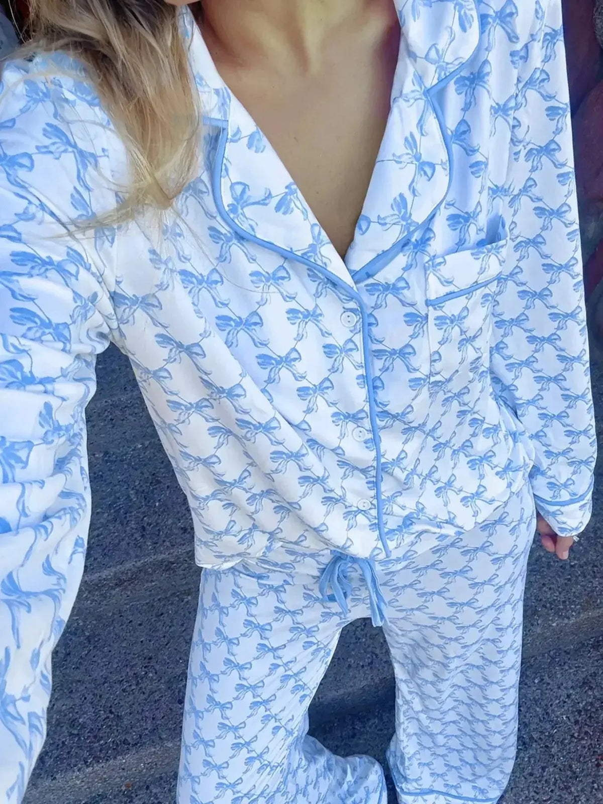 Women's bow print long sleeve pajama set from Plush Fashion Hub, featuring a comfortable button-down shirt and matching pants.
