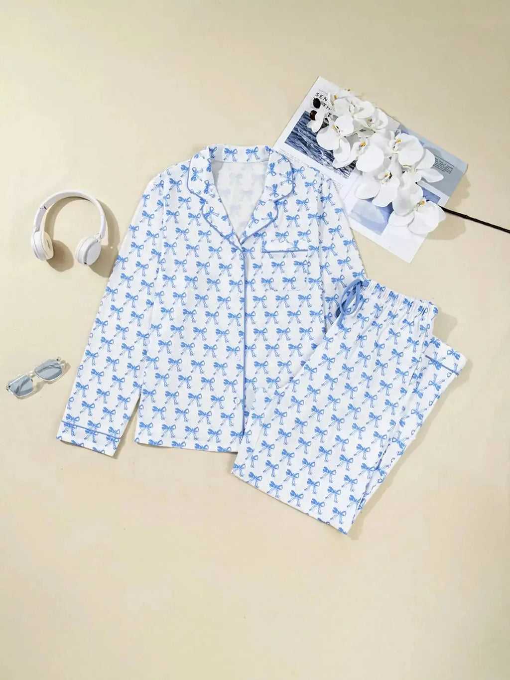 Women's bow print long sleeve button-down pajama set by Plush Fashion Hub, featuring soft loungewear with matching shirt and pants.