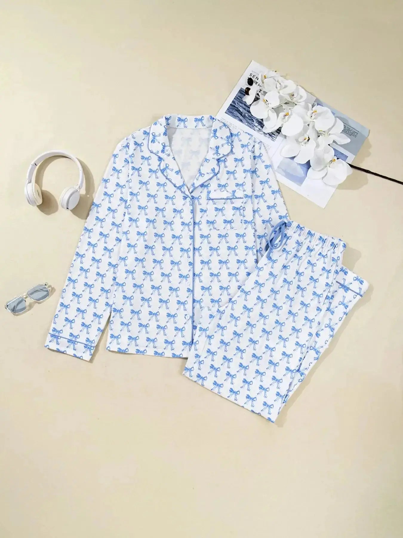 Women's bow print long sleeve button-down pajama set by Plush Fashion Hub, featuring soft loungewear with matching shirt and pants.