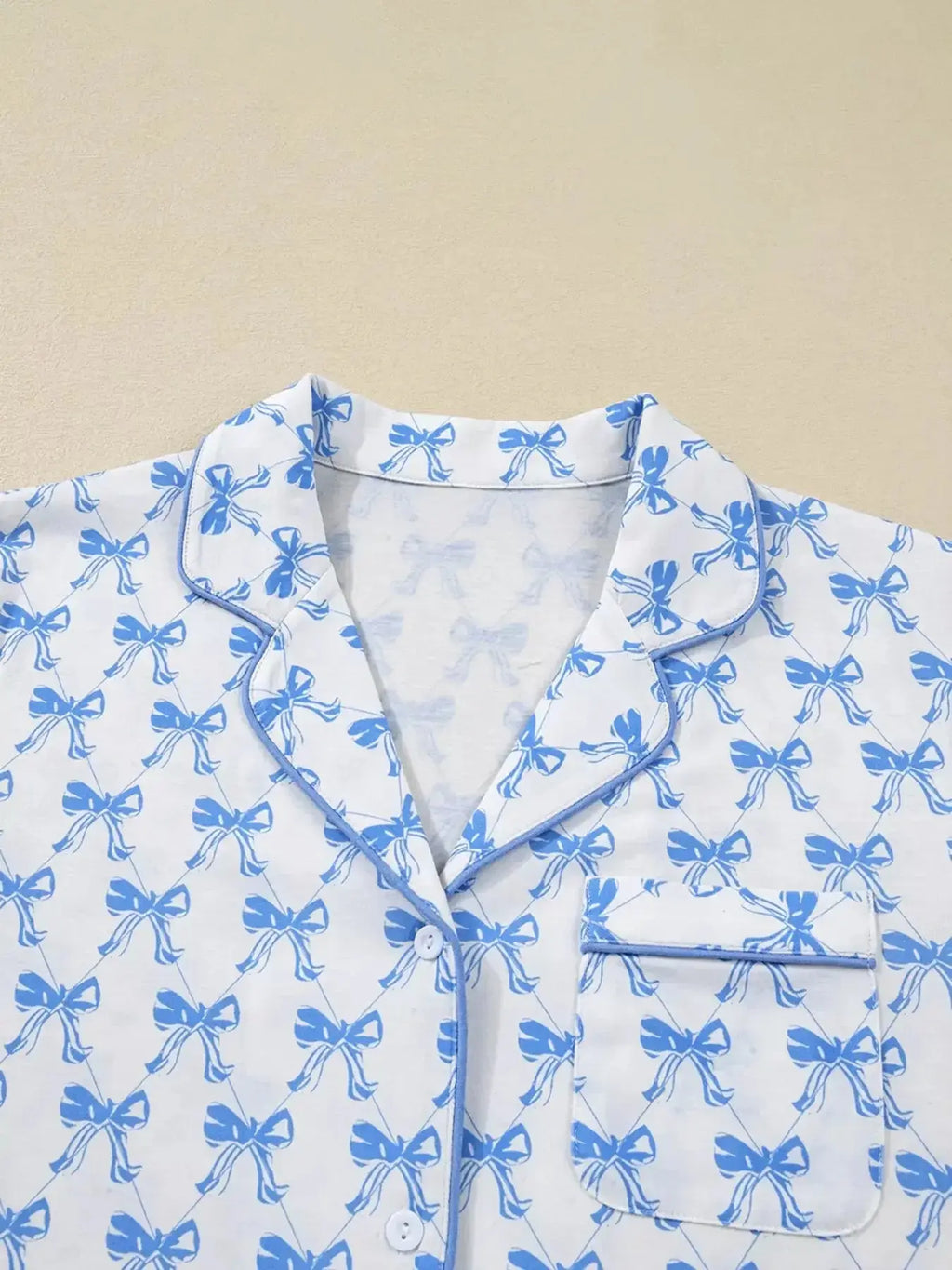 Women's bow print long sleeve pajama set by Plush Fashion Hub featuring a button-down shirt and matching pants in soft loungewear fabric.