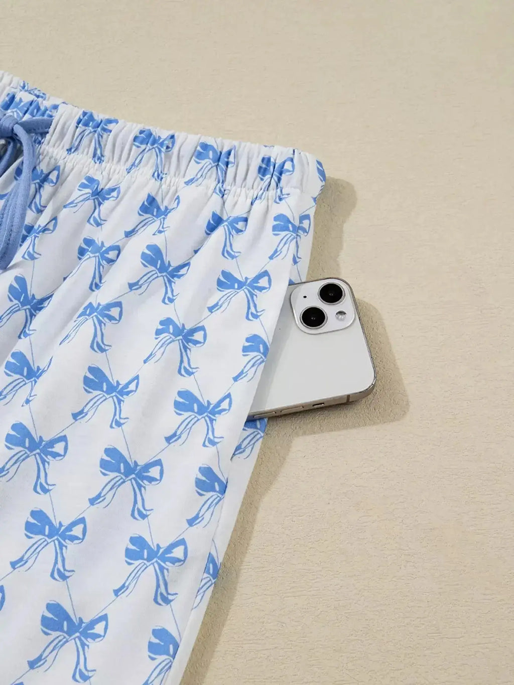 Women's bow print long sleeve pajama set with button-down shirt and matching pants from Plush Fashion Hub, soft loungewear for comfort.