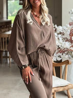Braided V-neck long sleeve top and high-waist pants lounge set by Trendsi, casual and comfortable for relaxed wear.