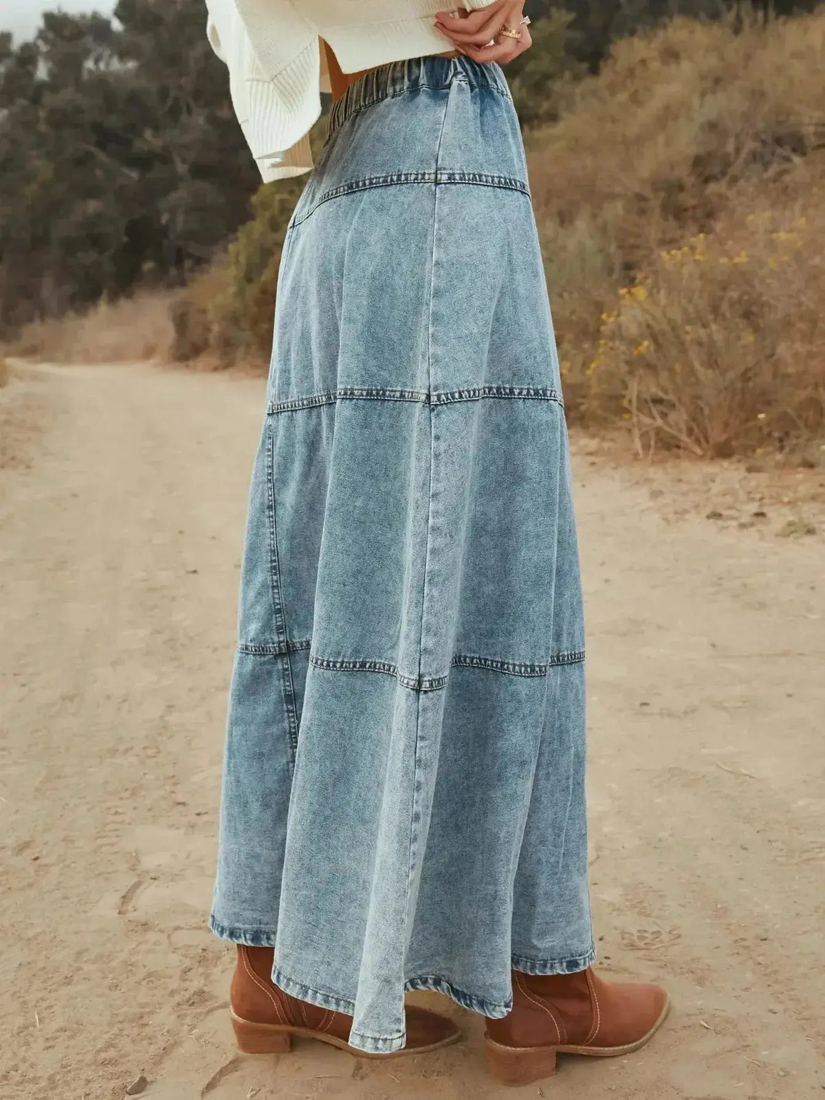 Flowy, button-front tiered maxi denim skirt by Plush Fashion Hub, showcasing a casual, long jean skirt with a trendy tiered design.