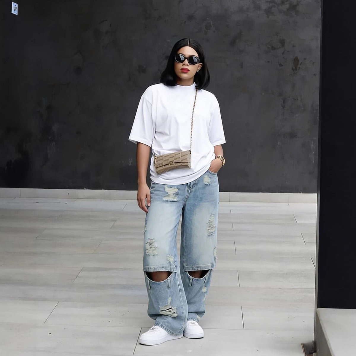 Light wash distressed ripped knee denim jeans by Plush Fashion Hub, showcasing a casual fit and trendy worn look.