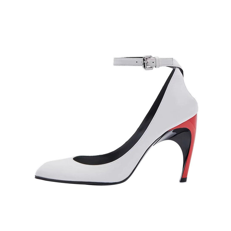 Modern white leather pointed-toe stiletto with ankle strap, silver buckle, and colorblock red and black sculptural heel.