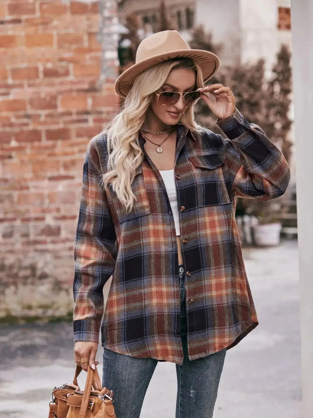 Women’s classic plaid long sleeve button-down shirt by Plush Fashion Hub, featuring a timeless checkered pattern and collar details.