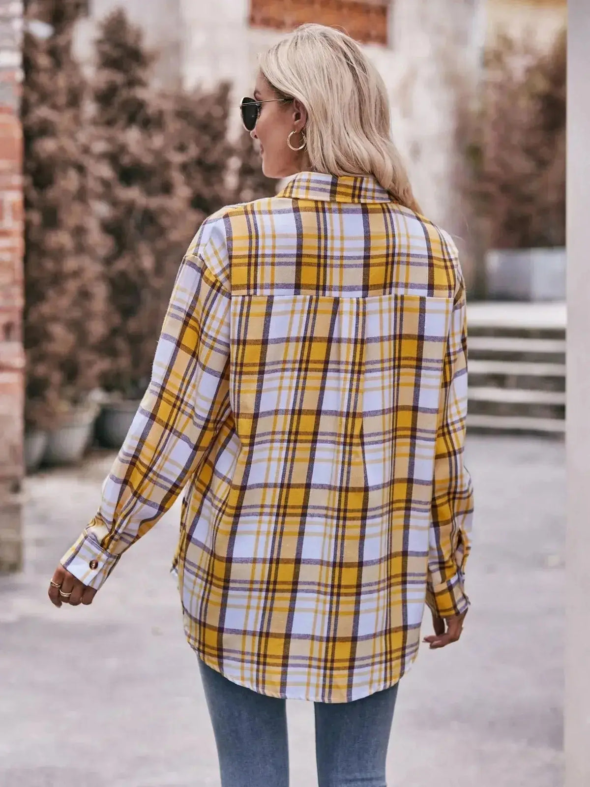 Women’s plaid long sleeve button-down shirt by Plush Fashion Hub featuring a classic pattern and relaxed fit.