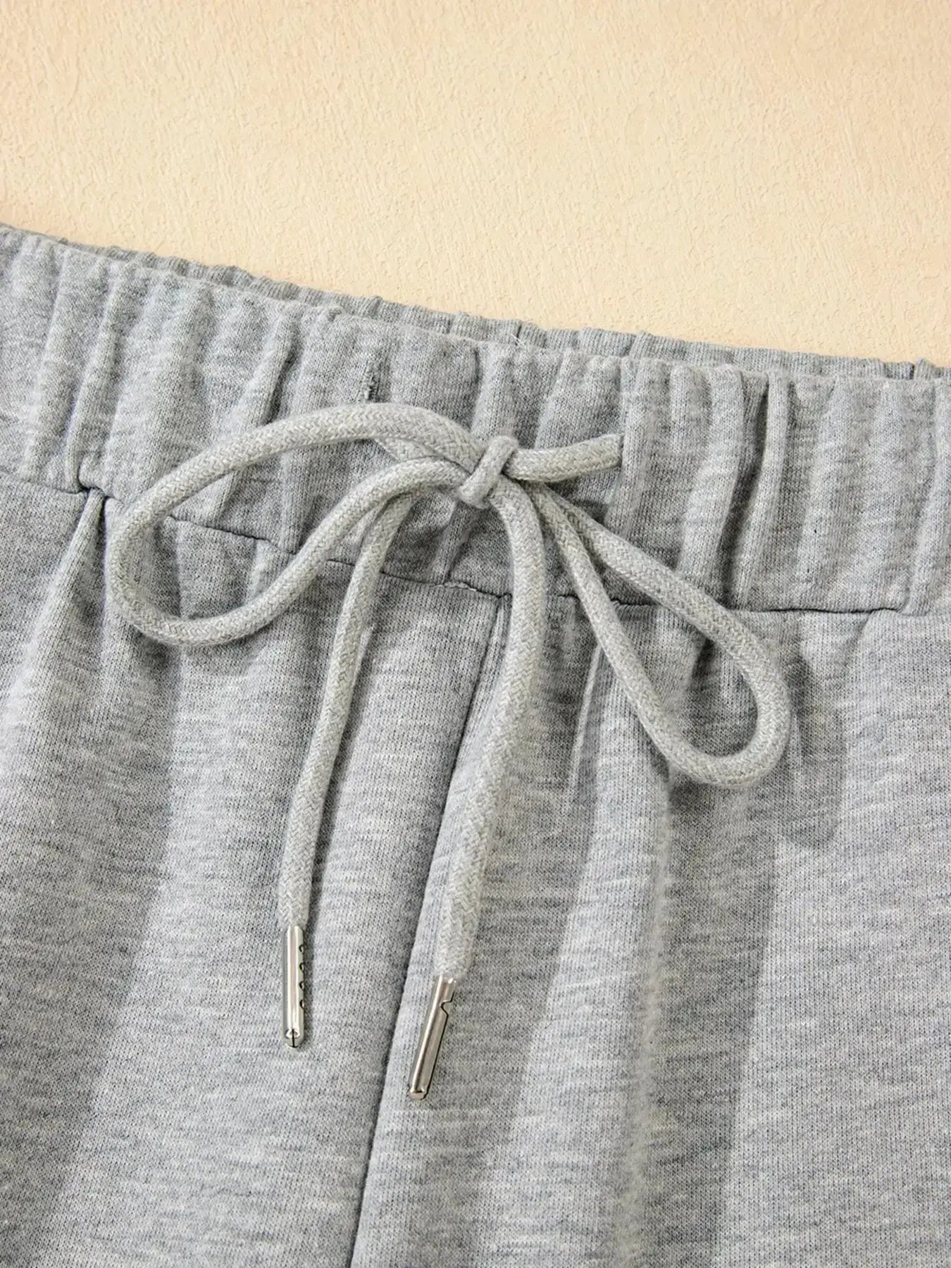 Contrast trim lounge pants from Trendsi, cozy two-piece set with round neck top and matching comfortable pants.