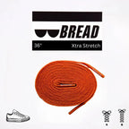 Coral orange elastic shoelace by Bread, showing the flexible, vibrant laces with a close-up of the textured material.