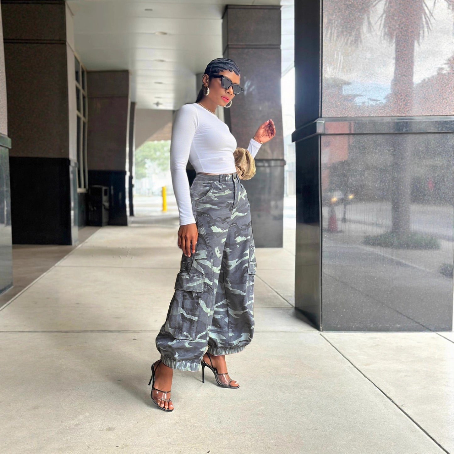 Women’s camouflage wide-leg cargo denim jeans by eprolo, showcasing distressed details and a relaxed fit with multiple cargo pockets.