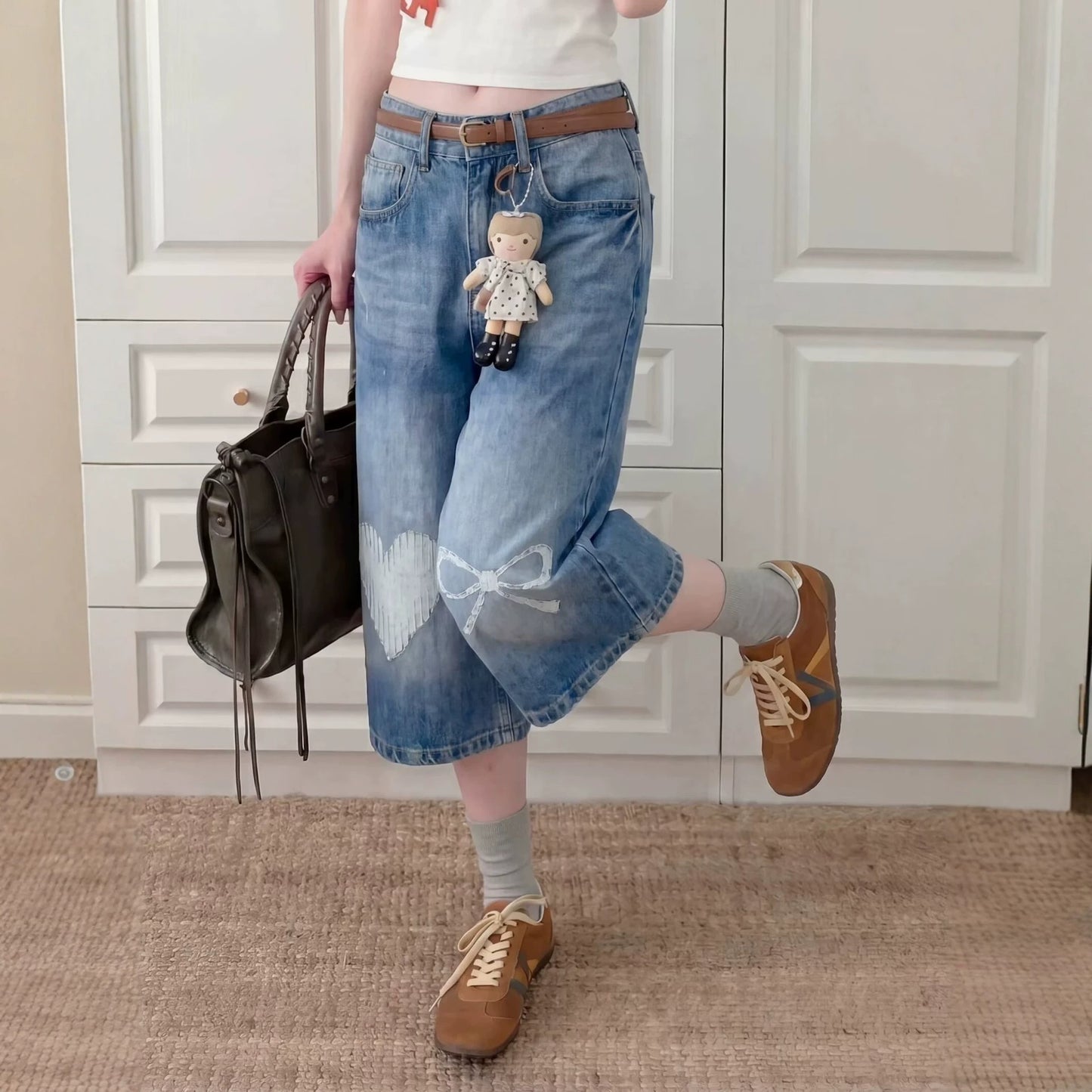 Eprolo washed bleached wide-leg straight jeans shown on a model, featuring a relaxed fit and distressed denim style.