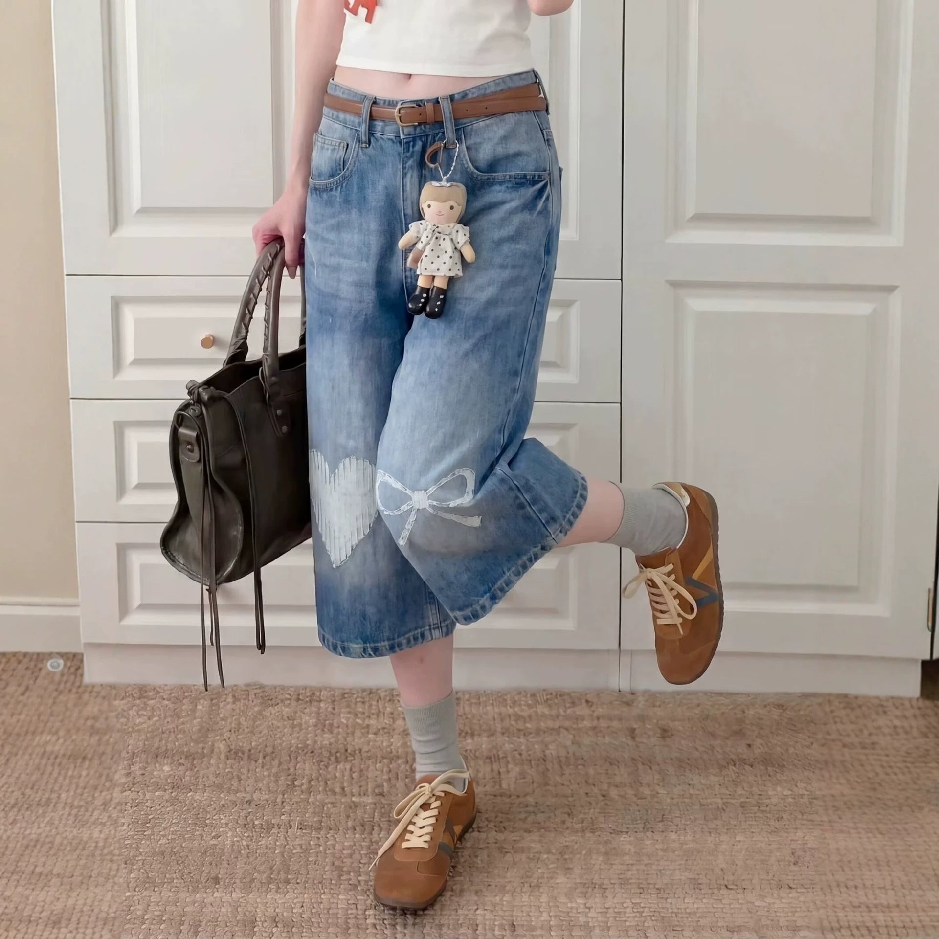 Eprolo washed bleached wide-leg straight jeans shown on a model, featuring a relaxed fit and distressed denim style.