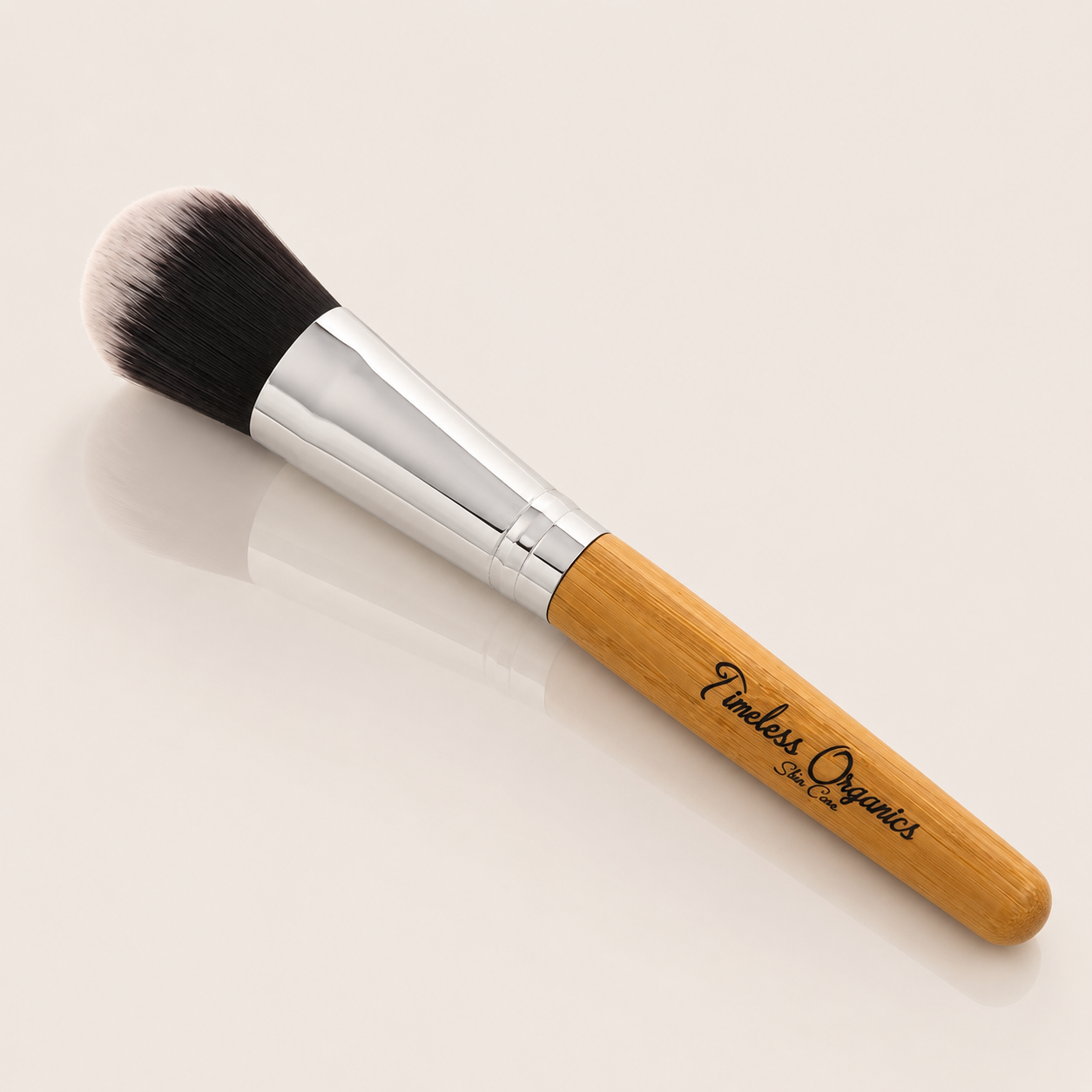 Natural bamboo beauty brush by Timeless Organics Skin Care with soft bristles for gentle skincare application.
