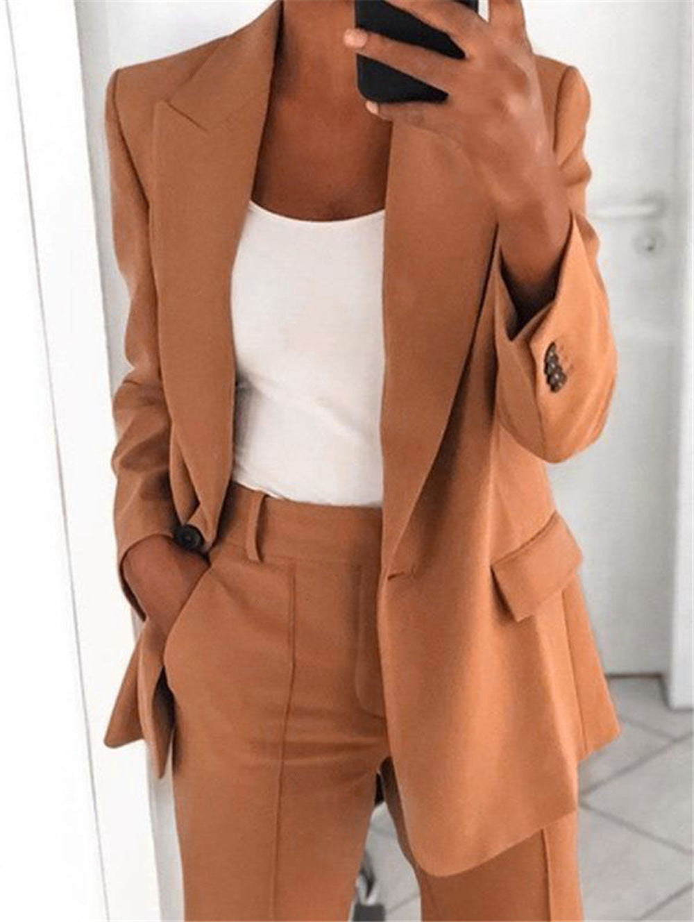 Slim fit blazer with notched collar in dark fabric, tailored from Plush Fashion Hub, stylish outerwear for formal or business wear.