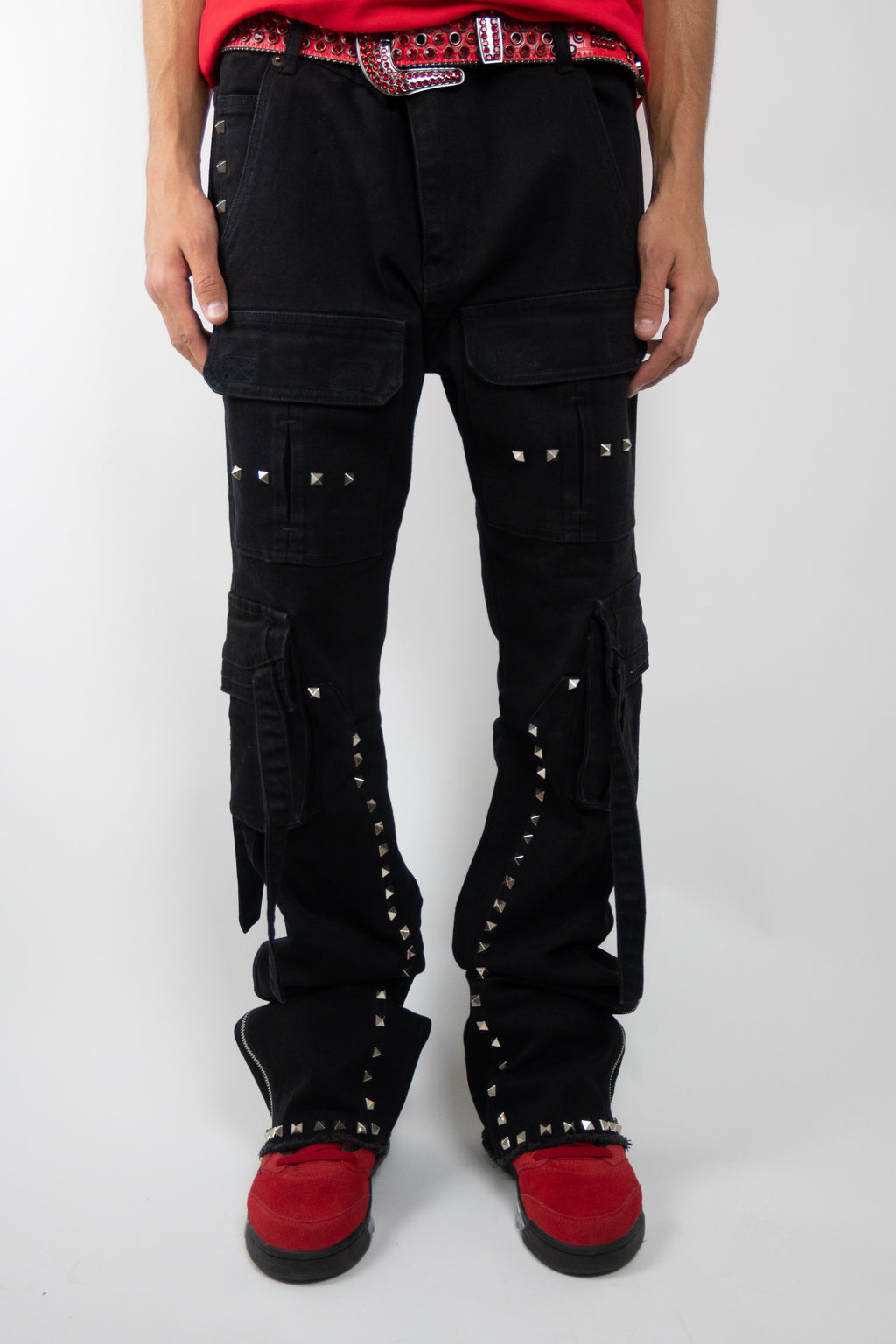 Armored Jeans RM206SK studded stacked cargo jeans with multiple pockets and metal stud embellishments, displayed folded on a white background.