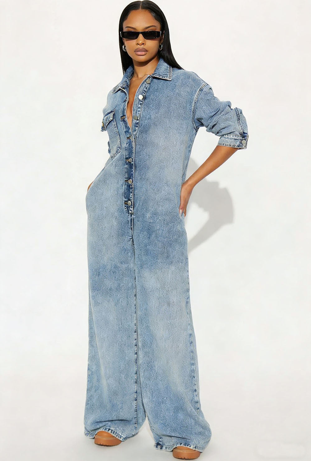 Women’s long sleeve denim jumpsuit with button-front closure by Plush Fashion Hub, featuring a stylish and casual design.