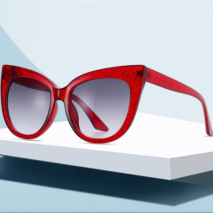 Women's oversized cat eye sunglasses with UV400 protection from Plush Fashion Hub, featuring black frames and tinted lenses.
